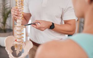 A young athlete receiving a chiropractic adjustment on a padded table in a clinical setting.