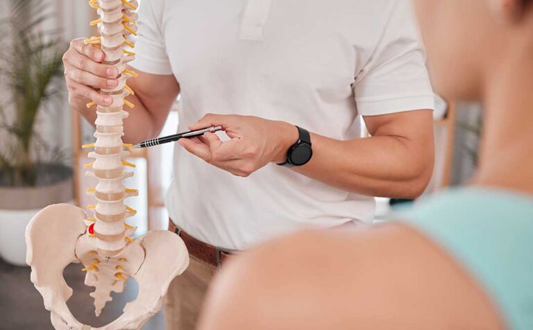 A young athlete receiving a chiropractic adjustment on a padded table in a clinical setting.